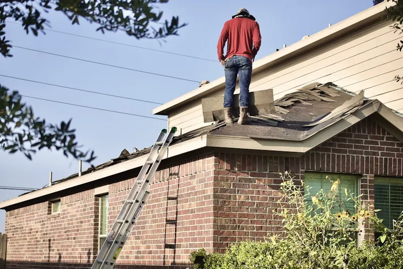 Professional roofer working on a residential roof in Barnes